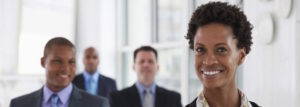 Smiling businesswoman with colleagues in meeting room